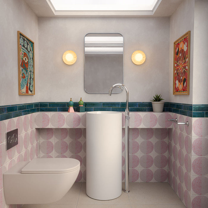 Bathroom featuring Eclipse Rosa Terrazzo Style Decor Tiles 20cm x 20cm, paired with glossy teal wall tiles, a freestanding basin, terrazzo effect floor tiles and contemporary minimalist fittings.