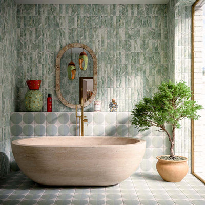 Bathroom featuring Eclipse Salvia 20x20cm terrazzo-effect patterned wall and floor tiles, styled with a freestanding stone bath, green marble-effect brick tiles, brushed brass fixtures and botanical-inspired contemporary décor