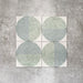 Eclipse Salvia 20x20cm terrazzo-style decor tiles featuring a soft sage and pale blue circular pattern, designed to bring a playful yet calming geometric look to contemporary interiors.