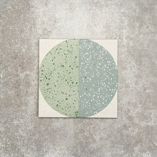 Eclipse Salvia 20x20cm terrazzo-style decor tiles featuring a soft sage and pale blue circular pattern, designed to bring a playful yet calming geometric look to contemporary interiors.
