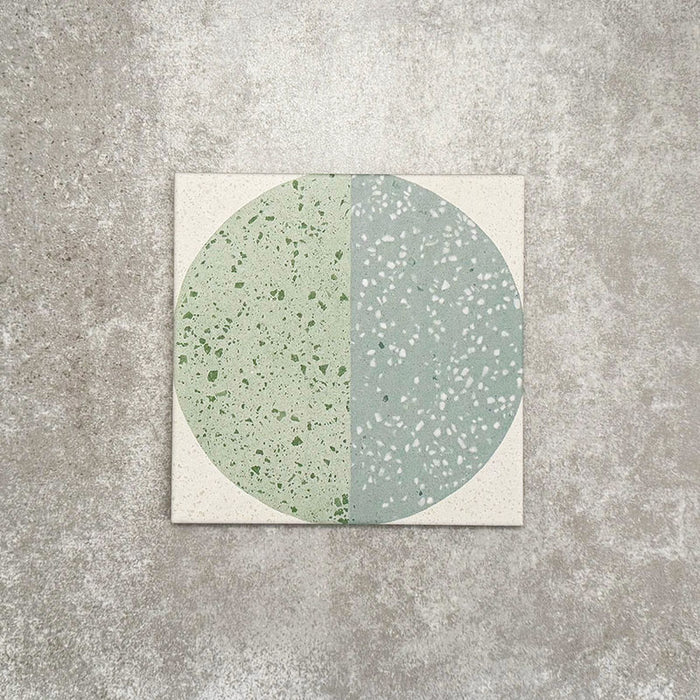 Eclipse Salvia 20x20cm terrazzo-style decor tiles featuring a soft sage and pale blue circular pattern, designed to bring a playful yet calming geometric look to contemporary interiors.