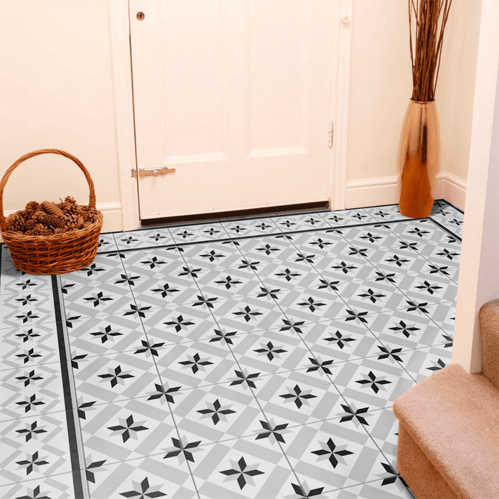 Entranceway featuring Canterbury Star Victorian-style porcelain floor tiles in a 20 × 20cm format, laid in a repeating star pattern and finished with a coordinating border tile, paired with warm neutral walls and classic accessories to create a welcoming, period-inspired entrance.