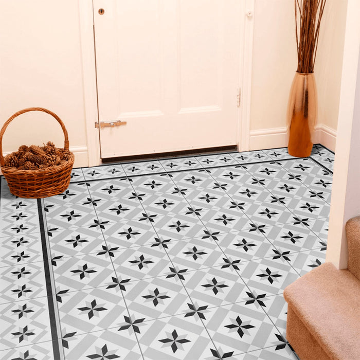 Entranceway featuring Canterbury Star Victorian-style porcelain floor tiles in a 20 × 20cm format, laid in a repeating star pattern and finished with a coordinating border tile, paired with warm neutral walls and classic accessories to create a welcoming, period-inspired entrance.