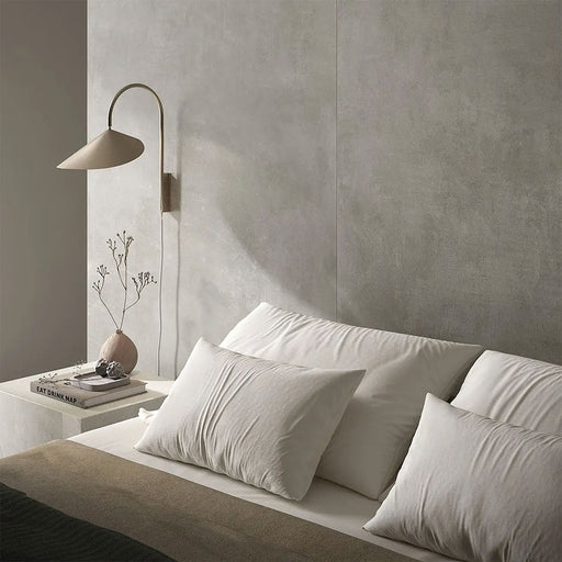 Bedroom interior featuring Etna Grey Matt 60 × 60cm porcelain wall tiles, styled with soft neutral bedding, a minimalist bedside table, and warm lighting for a calm, contemporary, restful space.