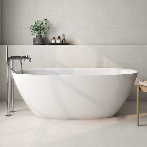 Bathroom interior featuring Etna Marfil Matt 60 × 60cm porcelain wall and floor tiles, styled with a freestanding bath, chrome fittings, and soft neutral tones for a calm, modern, spa-like setting.
