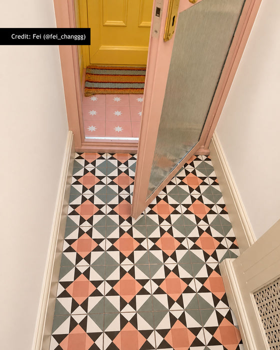 Entrance hallway featuring Farnham Manor Victorian style 20cm x 20cm floor tiles, with a bold geometric pattern in soft pink, green, black and white, leading through to a colourful adjoining space.