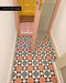 Entrance hallway featuring Farnham Manor Victorian style 20cm x 20cm floor tiles, with a bold geometric pattern in soft pink, green, black and white, leading through to a colourful adjoining space.