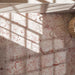 Close-up of Fayrouz Sylvester Pink 30.5cm x 61cm natural marble floor tiles, showcasing distinctive pink and rose veining across a soft cream base with natural variation between each tile.