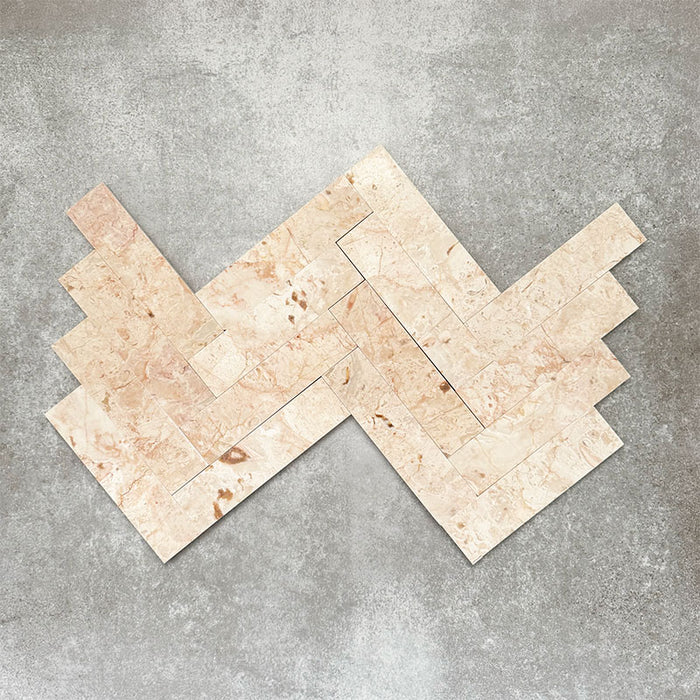 Herringbone tile layout showcasing Fayrouz Sylvester Pink 5cm x 20cm honed natural marble tiles, featuring soft pink, cream and beige tones with natural veining, perfect for elegant walls and decorative floors.