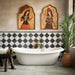 Bathroom featuring Fayrouz Verde tumbled natural marble tiles in a striking diamond pattern around a freestanding bath, complemented by brass fixtures, warm neutral walls, botanical décor and Persian-inspired artwork for a luxurious, characterful finish.