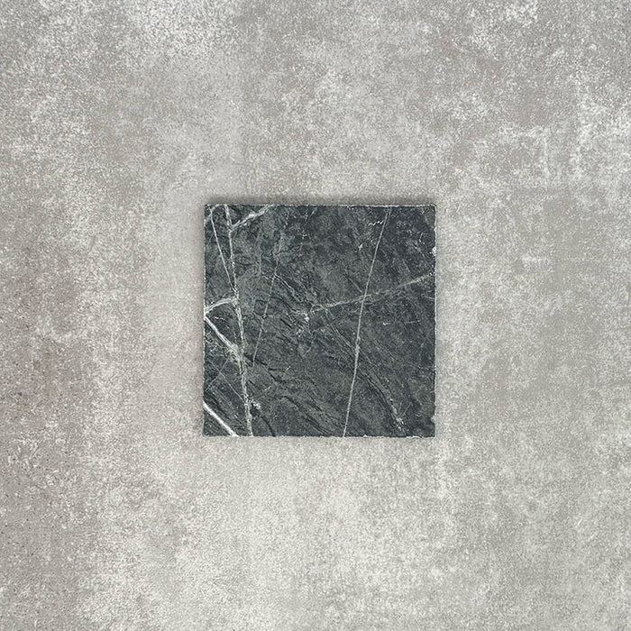 Close-up of Fayrouz Verde tumbled natural marble tiles in a 15.2cm x 15.2cm format, showcasing rich deep green tones, striking white veining and authentic stone variation with a beautifully aged tumbled finish.