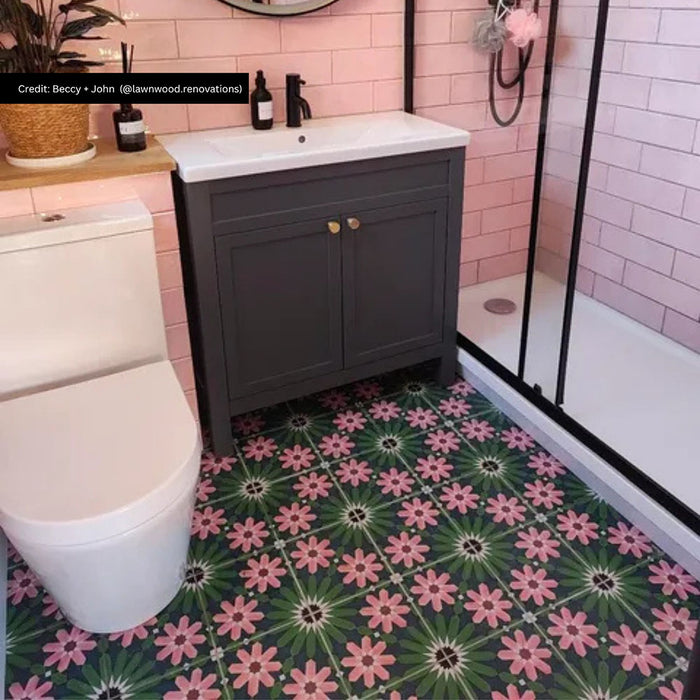 Bathroom featuring Fez Autumn 20cm x 20cm Moroccan-style floor tiles with a pink and green floral pattern, paired with blush pink metro tiles, a dark vanity unit and contemporary black shower framing.