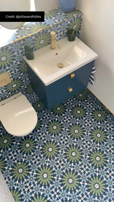Bathroom featuring Fez Springs 20x20cm Moroccan-style patterned floor and wall tiles in deep blue and green tones, styled with a navy vanity unit, brushed brass fixtures, and contemporary décor.