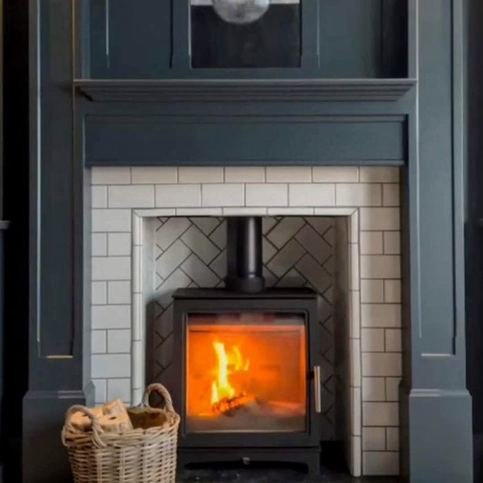 Fireplace surround featuring Pimlico White 7.5 × 15cm ceramic tiles with a crackle glaze finish, laid in a classic brick pattern and paired with herringbone detailing for a timeless, characterful look.