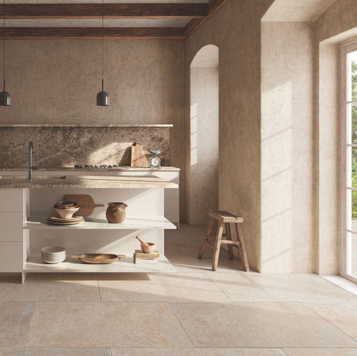 Kitchen interior featuring Flagstone Beige Tumbled Travertine 50 × 100cm porcelain floor tiles, styled with warm plaster-effect walls, rustic wood accents, and soft natural light for a relaxed, Mediterranean-inspired feel.