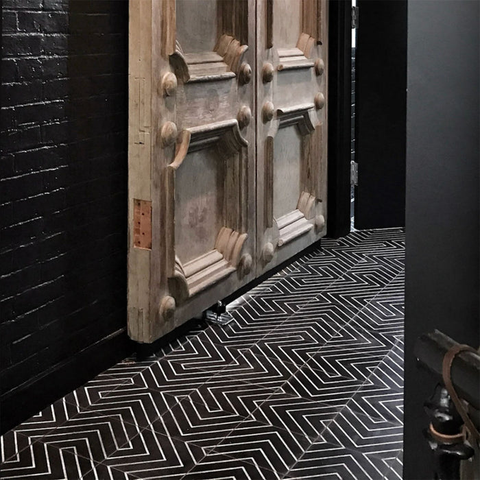 Hallway floor featuring Almeria Jilani Black Moroccan-style porcelain tiles in a striking white line geometric chevron pattern, 20x20cm, creating a bold and contemporary walkway.