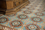 Interior floor setting featuring London Streets Hanover Square 20x20cm Victorian Moroccan style floor tiles, showcasing the repeating blue, terracotta and cream geometric pattern, styled alongside a traditional wooden cabinet for a classic decorative floor design.