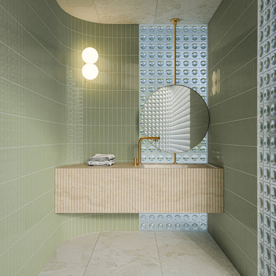 Bathroom featuring Gallery 3D Fluted Decor Tansy Green Gloss 5cm x 20cm wall tiles, paired with textured feature tiles, a floating stone vanity, round mirror and brass fixtures.