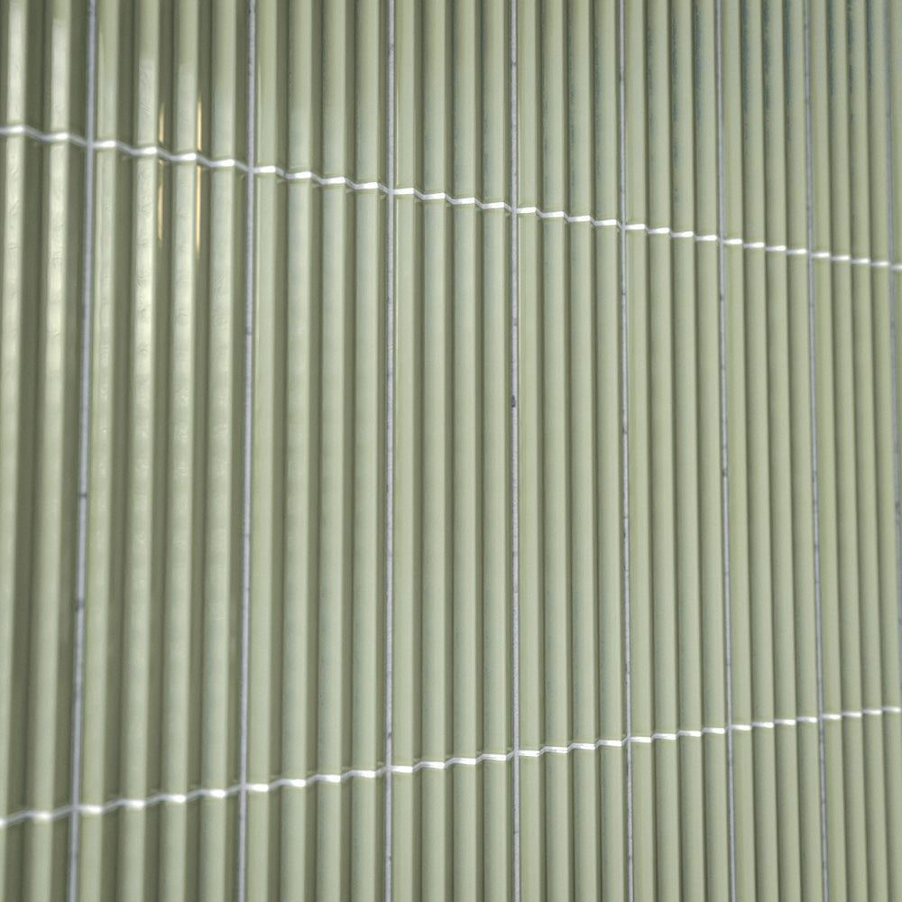 Close-up of Gallery 3D Fluted Decor Tansy Green Gloss 5cm x 20cm wall tiles, showcasing the raised fluted texture, soft green tone, glossy finish and subtle surface variation.