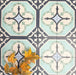 Group of London Streets Goodwin Court 20x20cm Victorian Moroccan style porcelain tiles arranged to showcase the repeating soft blue, cream and charcoal geometric pattern, styled with autumn leaves in a decorative flat-lay setting.