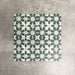 Souk Green C 20×20cm Moroccan-style porcelain tiles arranged in a green, white and beige geometric pattern.