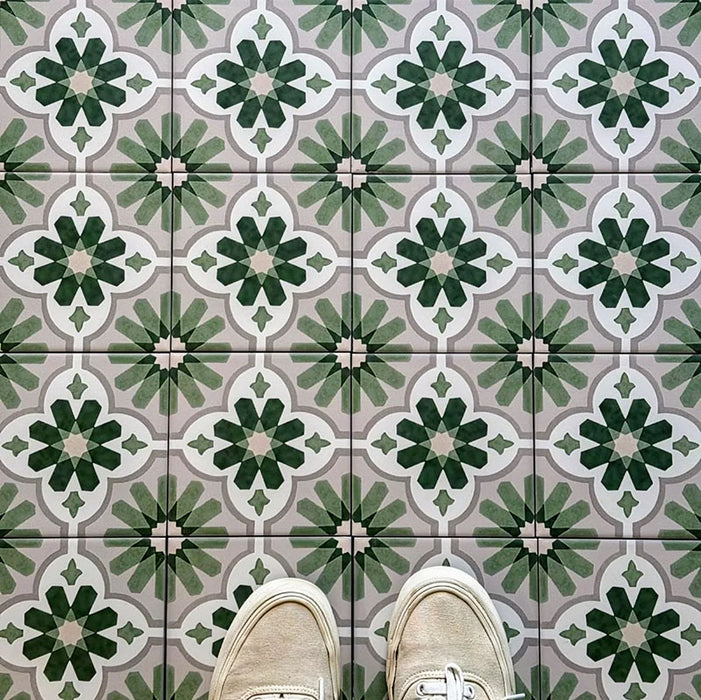 Clara Jade Mini Victorian Moroccan-style porcelain floor tiles in a 15 × 15cm format, laid in a repeating pattern to showcase the green geometric design across the floor.