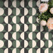 Abstract Circles Patterned Tiles in a 20x20cm format, shown in a repeating grid layout to highlight the bold circular design. Deep green, charcoal and soft cream tones create a striking yet balanced pattern, styled with floral accents to showcase the tiles as a decorative feature suitable for floors, walls or splashbacks.