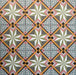 Cuba Star Mini Moroccan-style porcelain tiles in a 15×15cm square format, arranged in a repeating geometric star pattern with soft green, blue, pink and mustard tones, highlighting the tile’s crisp symmetry, fine detailing and decorative encaustic-style design.