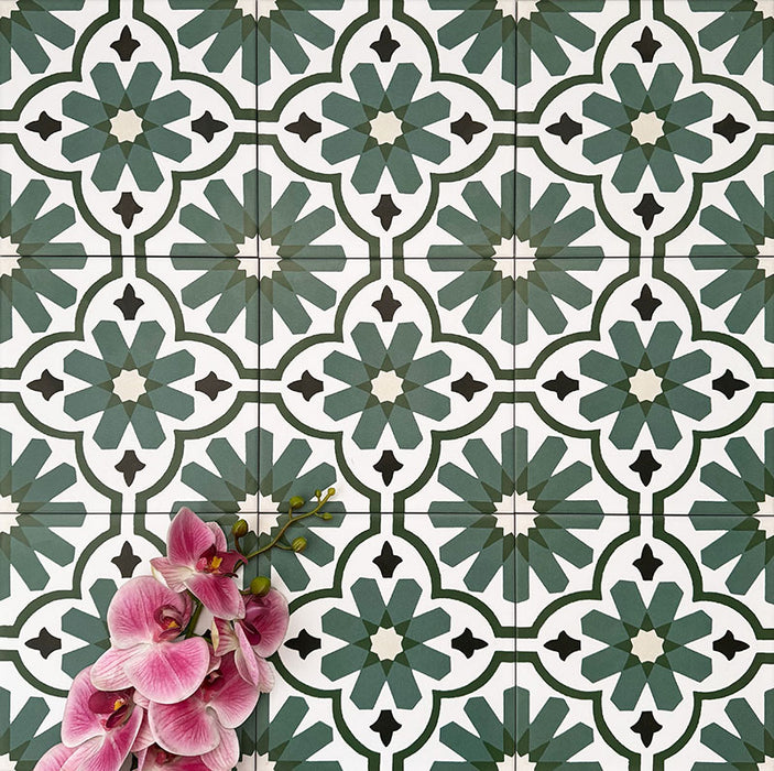 Clara Verde Victorian Moroccan-style porcelain floor tiles in a 20 × 20cm format, laid in a repeating pattern to highlight the bold green geometric design with decorative styling accents.