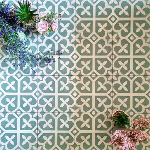 Ivy Green Victorian Moroccan style 20x20cm patterned tiles, shown in a flat lay with decorative plants highlighting the geometric design.