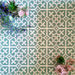 Ivy Green Victorian Moroccan style 20x20cm patterned tiles, shown in a flat lay with decorative plants highlighting the geometric design.