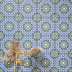 Fez Mini Springs 15x15cm Moroccan-style porcelain wall tiles arranged in a repeating geometric pattern, featuring layered blue and soft green star motifs, styled with dried foliage for a natural, decorative finish.