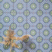 Fez Mini Springs 15x15cm Moroccan-style porcelain wall tiles arranged in a repeating geometric pattern, featuring layered blue and soft green star motifs, styled with dried foliage for a natural, decorative finish.