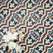 Close-up of Balthazar Grand 20×20cm Moroccan-style porcelain tiles laid in a repeating pattern, highlighting the bold geometric design in deep blue, warm brown and soft cream tones, styled with white orchid flowers to showcase the intricate encaustic-inspired detail and matt finish.