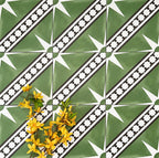 Gilgamesh Green Moroccan style 20x20cm patterned tiles, shown in a flat lay with decorative accessories highlighting the green, black and white geometric star design.