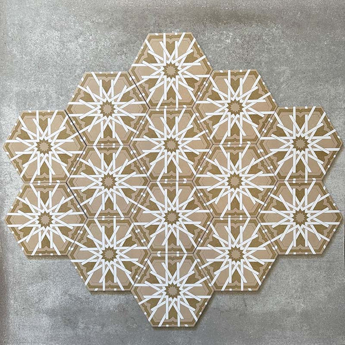 Grouped layout of Medina Hormuz Vintage Gold Moroccan-style hexagon porcelain tiles, 18.7 × 21.6 cm, showcasing the full repeating star-inspired geometric pattern in warm gold and white tones on a neutral background.