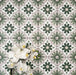 Clara Jade Mini Victorian Moroccan-style porcelain floor tiles in a 15 × 15cm format, laid in a repeating pattern to showcase the green geometric design across the floor.