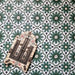 Clara Verde Victorian Moroccan-style porcelain floor tiles in a 20 × 20cm format, laid in a repeating pattern to highlight the bold green geometric design with decorative styling accents.