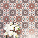 Fez Rosso Moroccan-style porcelain tiles laid in a repeating pattern, shown across multiple 20 × 20cm tiles. The intricate geometric design features rich terracotta and warm rust tones layered with soft blush pink star motifs, all set against a cool grey base. When tiled together, the pattern creates a striking rhythmic effect with depth and movement, balancing bold colour with symmetry. Ideal for statement floors or feature walls where you want a classic Moroccan look with a warm, contemporary edge.