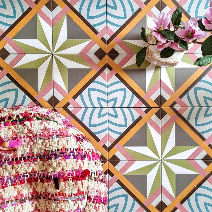 Cuba Star Moroccan-style porcelain tiles in a 20×20cm square format, arranged in a repeating geometric star pattern in soft green, blue, pink and mustard tones, shown from above to highlight the tile’s bold symmetry, crisp lines and decorative encaustic-style design.