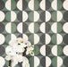 Abstract Circles Patterned Tiles in a 20x20cm format, shown in a repeating grid layout to highlight the bold circular design. Deep green, charcoal and soft cream tones create a striking yet balanced pattern, styled with floral accents to showcase the tiles as a decorative feature suitable for floors, walls or splashbacks.