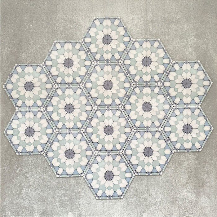 Grouped layout of Medina Frost Blue Moroccan-style hexagon porcelain tiles, 18.7 × 21.6 cm, displaying the full repeating geometric pattern in soft blue and white tones on a neutral background.