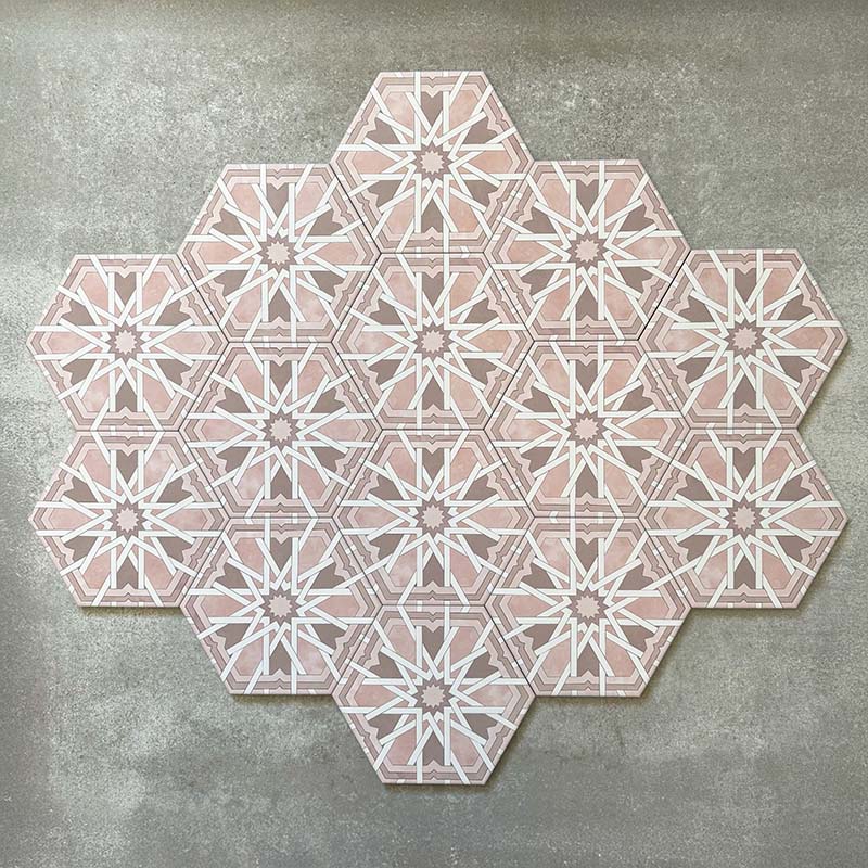 Grouped layout of Medina Hormuz Rose Moroccan-style hexagon porcelain tiles, 18.7 × 21.6 cm, showcasing the full repeating star-inspired geometric pattern in soft rose and white tones on a neutral background.