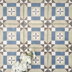 Viscount Harley Street 20×20cm Victorian-style porcelain wall and floor tiles laid in a repeating geometric square pattern with a central floral motif in soft blue, beige, warm grey and white tones, shown as a full tile layout with subtle tonal variation and floral styling.