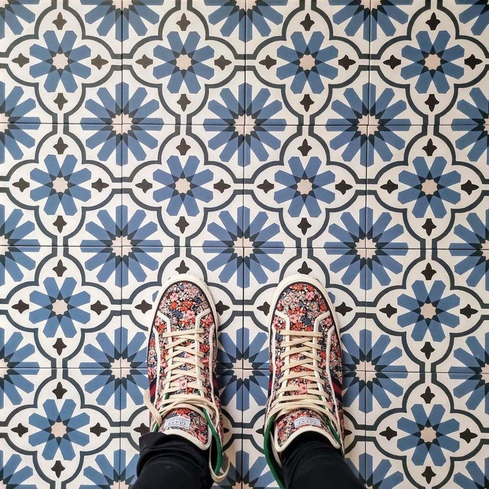 Clara Azul Victorian Moroccan-style porcelain tiles in a 20 × 20cm format, laid in a repeating pattern to showcase the blue and white geometric design across the surface.