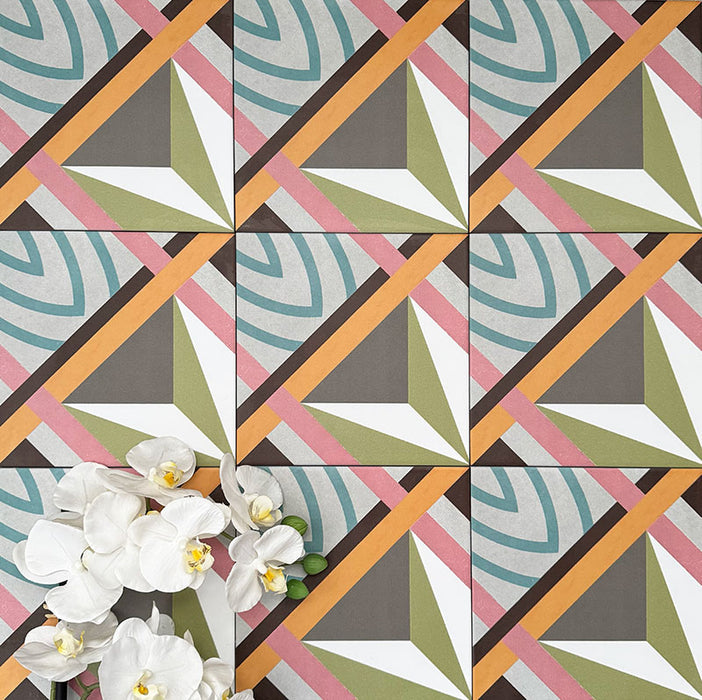 Cuba Star Moroccan-style porcelain tiles in a 20×20cm square format, arranged in a repeating geometric star pattern in soft green, blue, pink and mustard tones, shown from above to highlight the tile’s bold symmetry, crisp lines and decorative encaustic-style design.