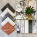 Tile moodboard featuring Fayrouz Viola 5x20cm natural marble tiles with a honed finish, styled alongside coordinating marble samples in white, grey and red tones with varied veining and complementary finishes.