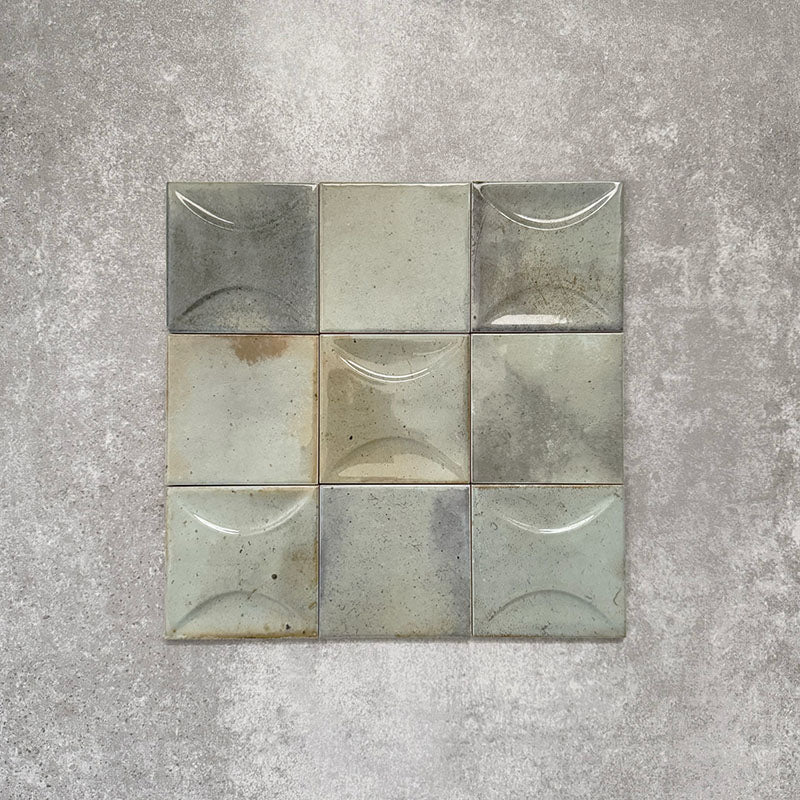 Saigon Celadon Green Square Wall tiles shown in a grouped layout, featuring Moroccan-style 10 × 10cm glossy ceramic tiles in soft green and blue-grey tones with natural surface variation.