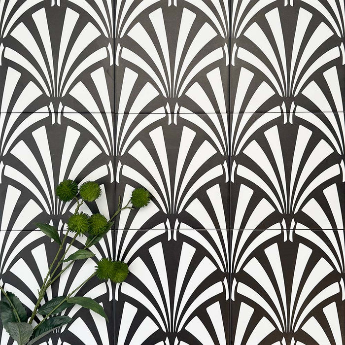 Almeria Casablanca Moroccan-style porcelain wall and floor tiles arranged in a repeating black and white fan pattern, 20x20cm, styled with greenery for a decorative display.