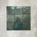Flat lay of Zellige Royal Green Square 13.2 × 13.2cm Moroccan-style ceramic tiles in rich deep green tones, arranged in a simple grid on a textured grey background, showcasing the glossy glaze, natural tonal variation and handcrafted zellige-effect finish.